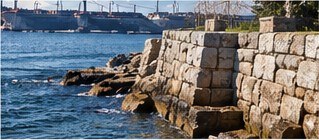 Granite block seawall along a harbor (illustrative photograph)