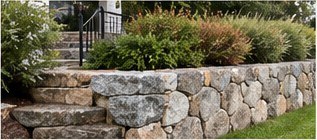 Granite stone retaining wall and steps with plantings (illustrative photograph)